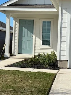 a front view of a house with garden