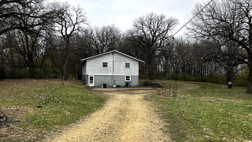 8919 Meredosia Road Albany, IL 61230 - Photo 8 of 35 a front view of house with yard and trees in the background