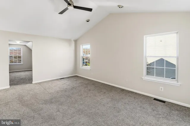 an empty room with windows and closet