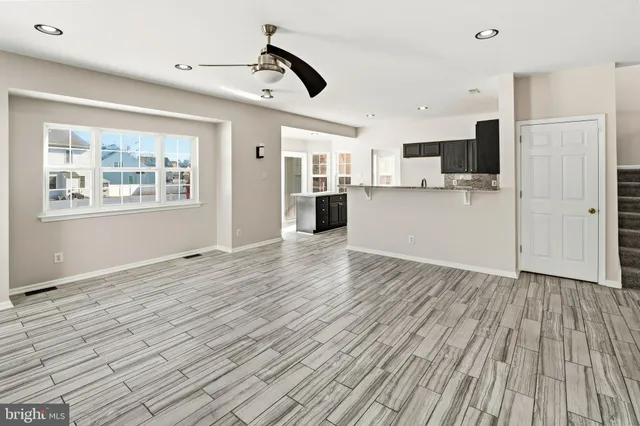 a view of a living room hardwood floor and a window