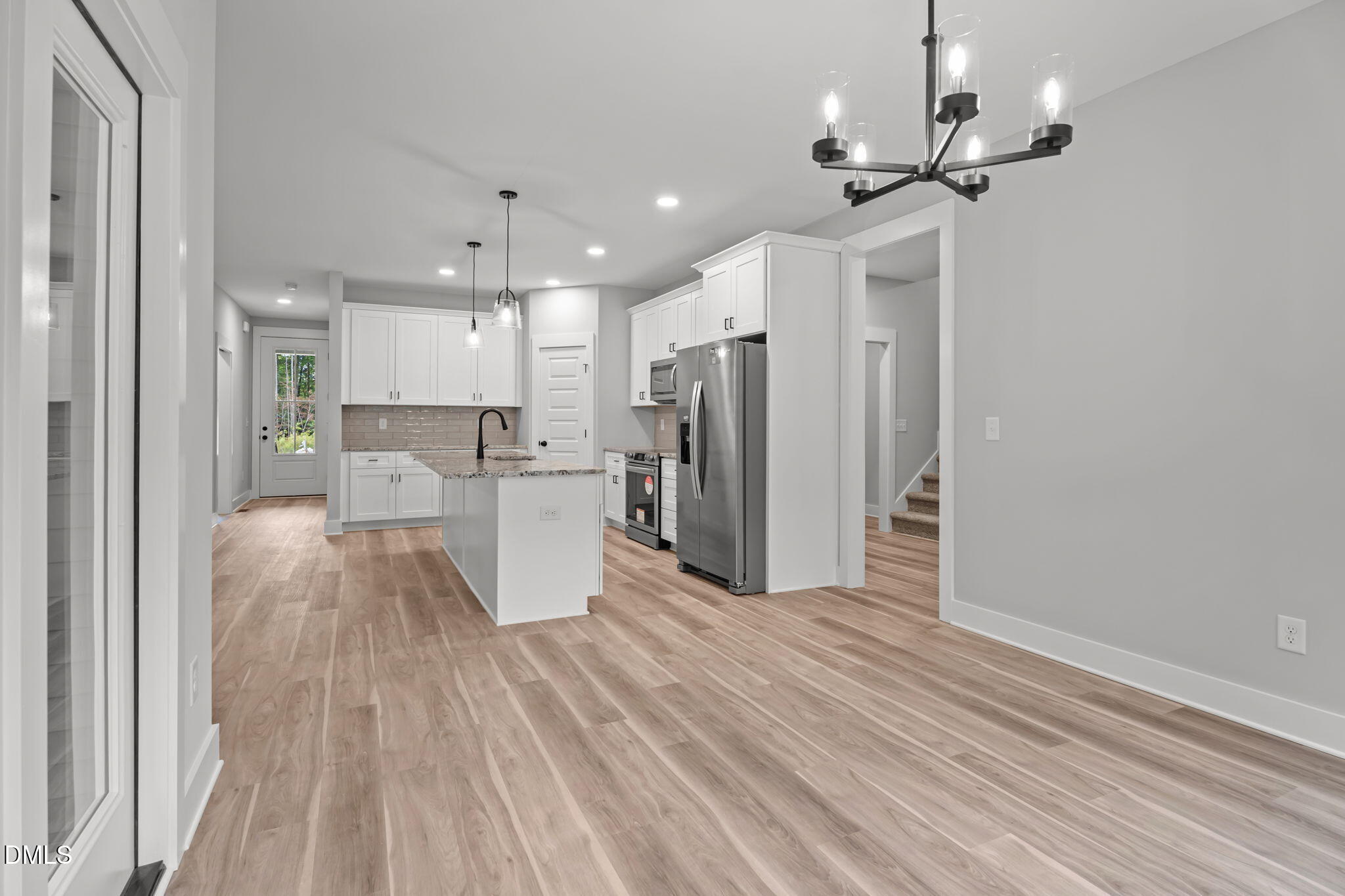 327 Little Lady Trail Zebulon, NC 27597 - Photo 34 of 49 a view of kitchen with stainless steel appliances refrigerator stove microwave and cabinets