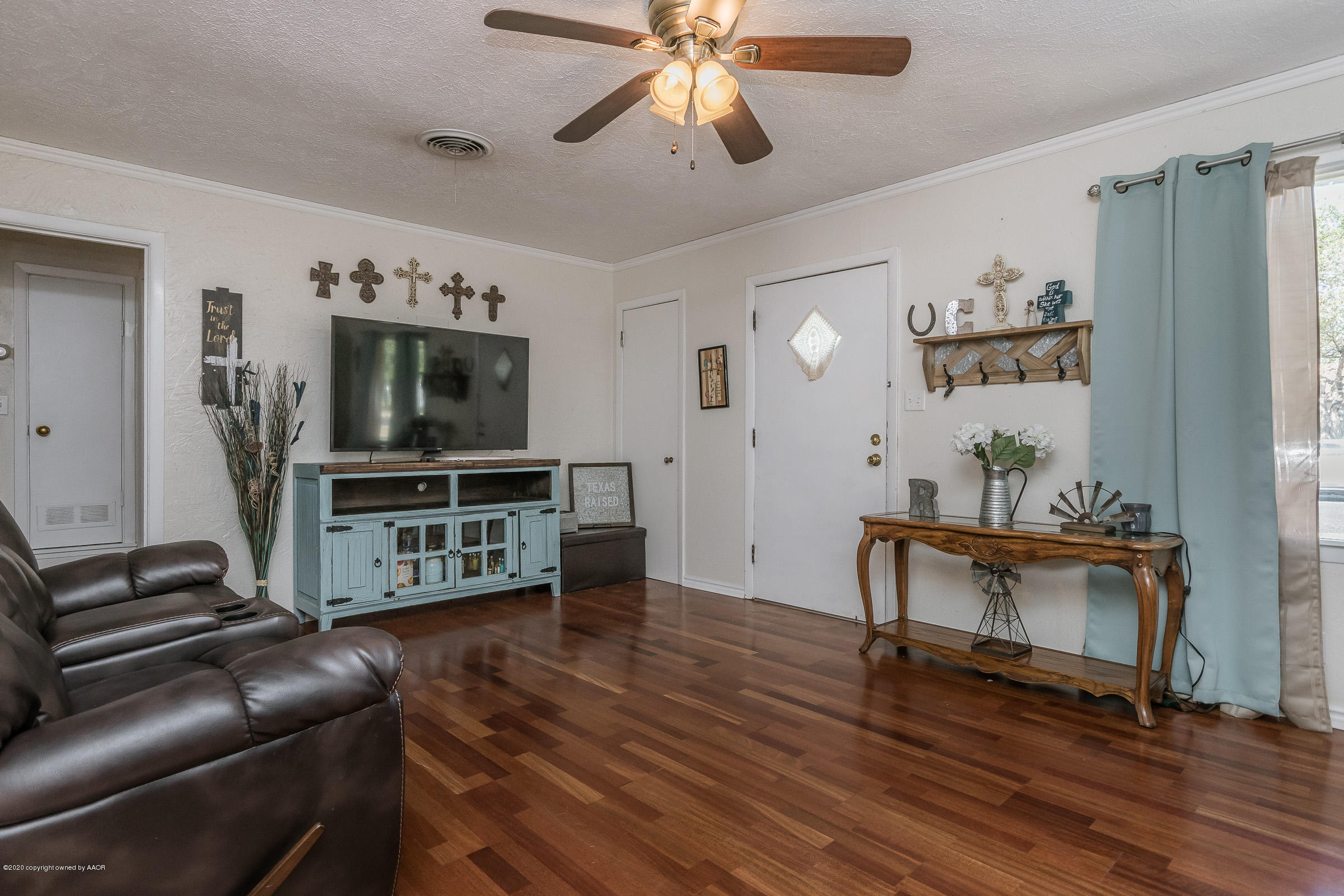 4311 South Monroe Street Amarillo, TX 79110 - Photo 3 of 17 a living room with furniture and a flat screen tv