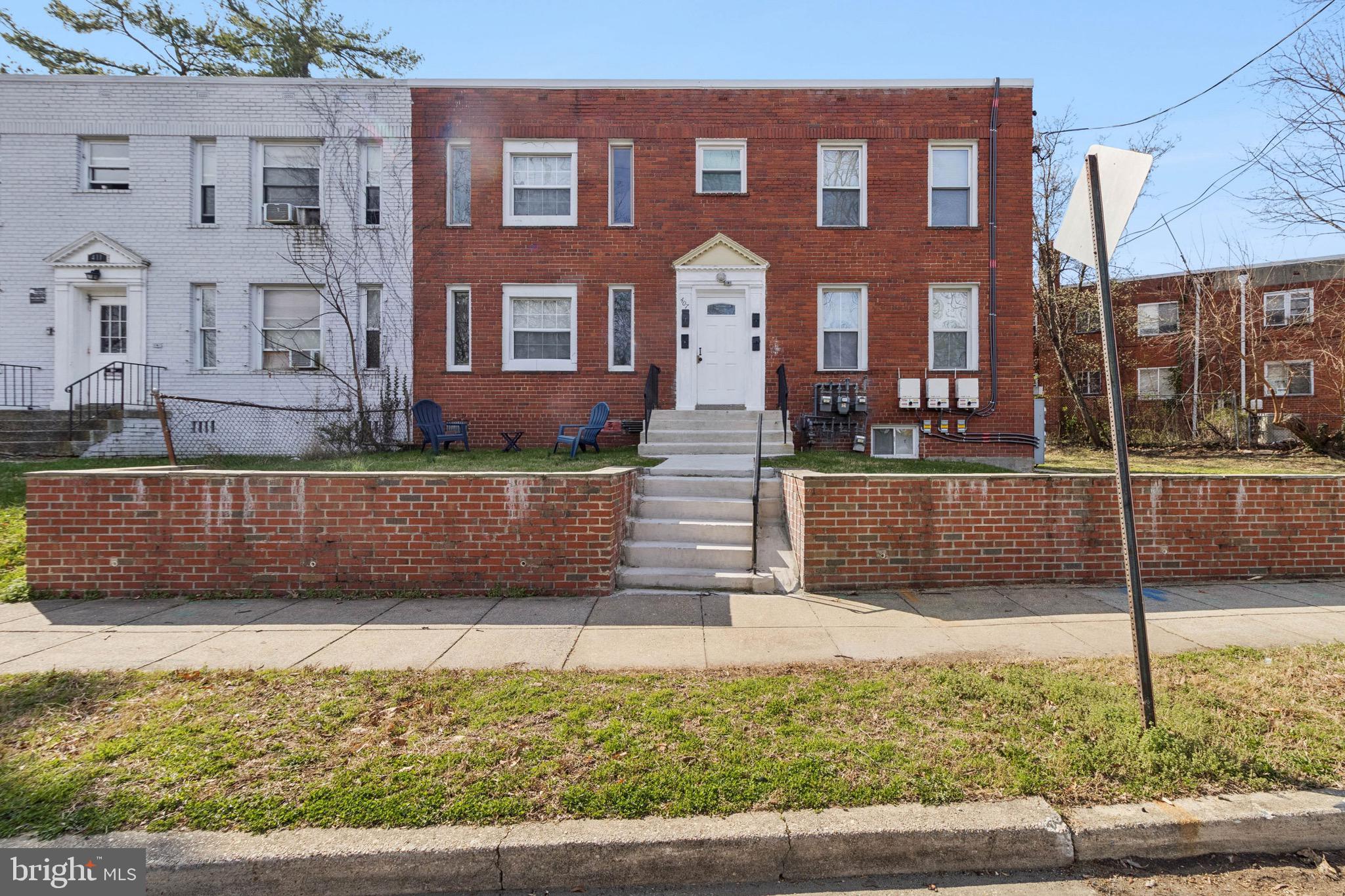 407 Lebaum Street Southeast, Unit 1 Washington, DC 20032 - Photo 2 of 11 a view of a brick building next to a yard
