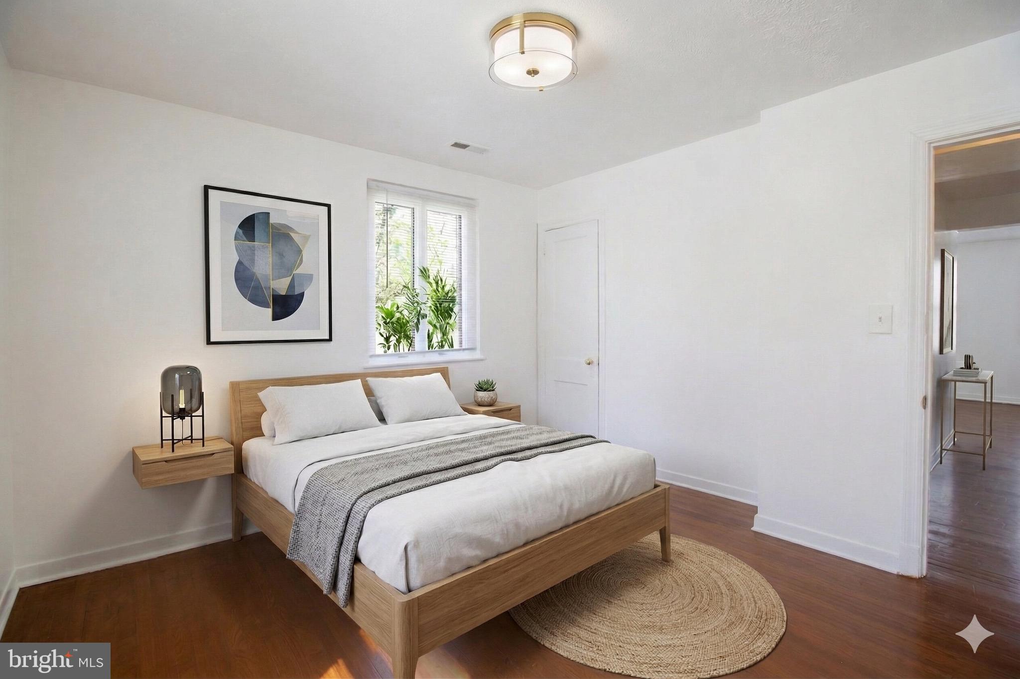 407 Lebaum Street Southeast, Unit 1 Washington, DC 20032 - Photo 5 of 11 a bedroom with a bed and a chair