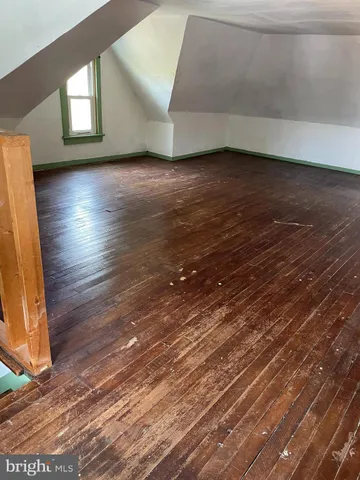 a view of wooden floor and windows in a room