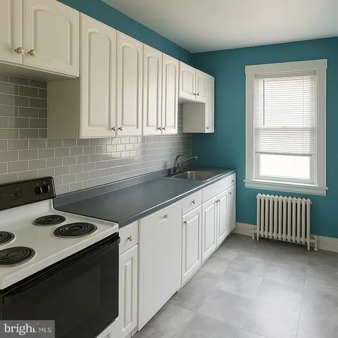 a kitchen with a sink stove and cabinets