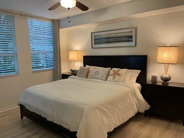 a bedroom with a bed and a lamp