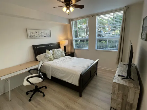 a bedroom with a bed window and a desk