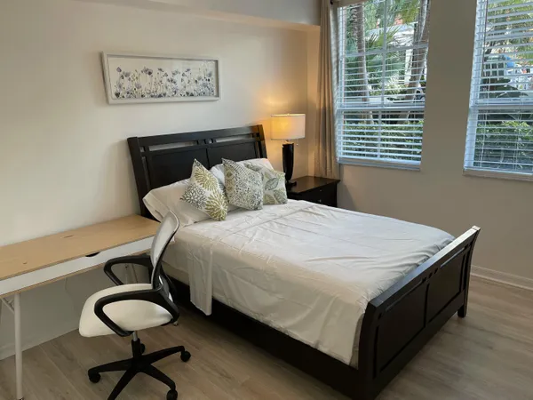 a bed sitting in a bedroom next to a window