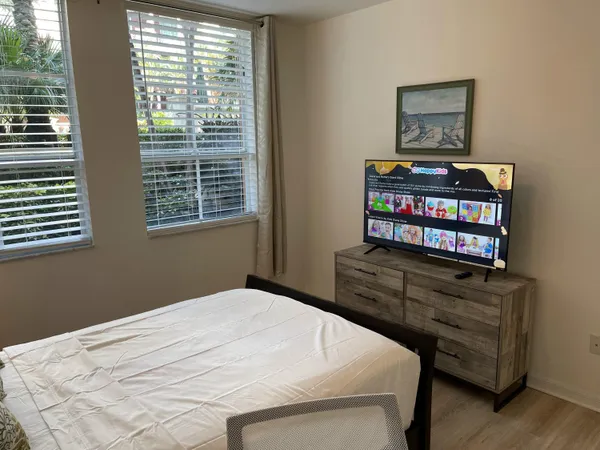 a bedroom with a bed window and cabinet