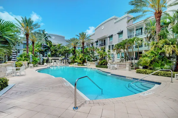 a view of a swimming pool with an outdoor seating