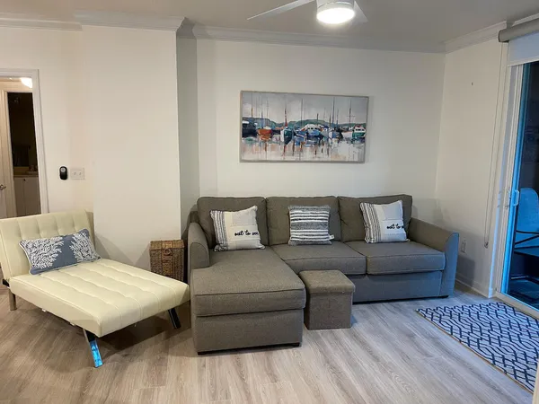 a living room with furniture and a wooden floor