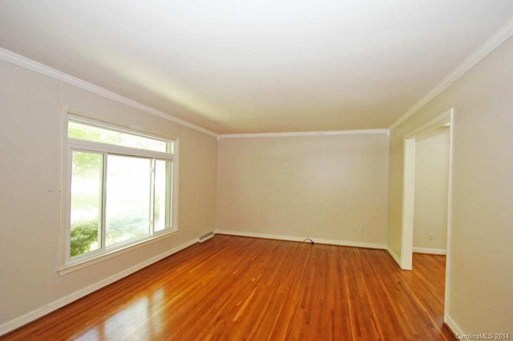 6723 Old Reid Road Charlotte, NC 28210 - Photo 3 of 7 an empty room with wooden floor and windows