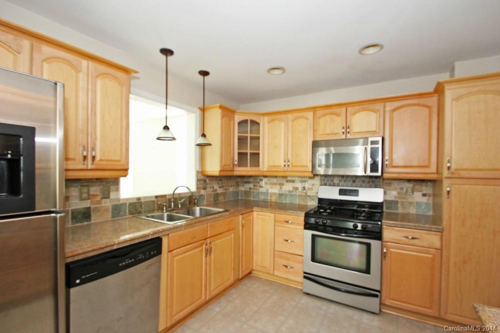 6723 Old Reid Road Charlotte, NC 28210 - Photo 5 of 7 a kitchen with stainless steel appliances a stove sink and refrigerator