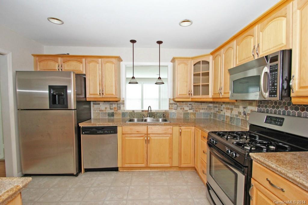6723 Old Reid Road Charlotte, NC 28210 - Photo 6 of 7 a kitchen with stainless steel appliances granite countertop a stove a sink and a microwave