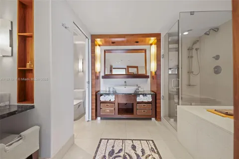 a view of a bathroom with tub shower and bedroom view