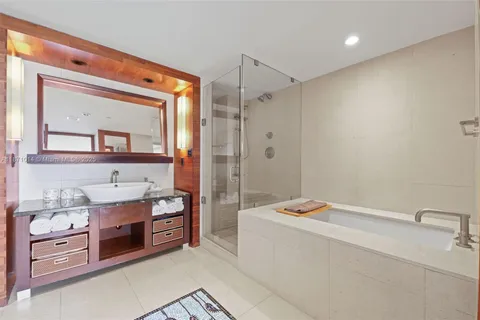 a en suite bathroom with a double vanity sink and a mirror