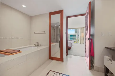 a spacious bathroom with a bathtub and a sink