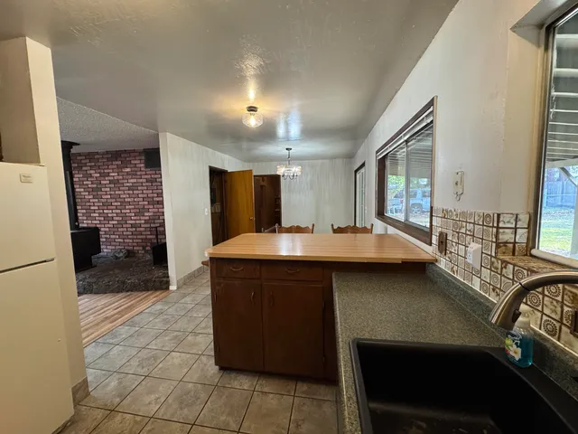a kitchen with a refrigerator and a stove top oven