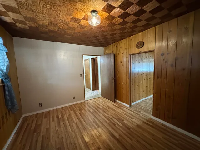 a view of hallway with wooden floor