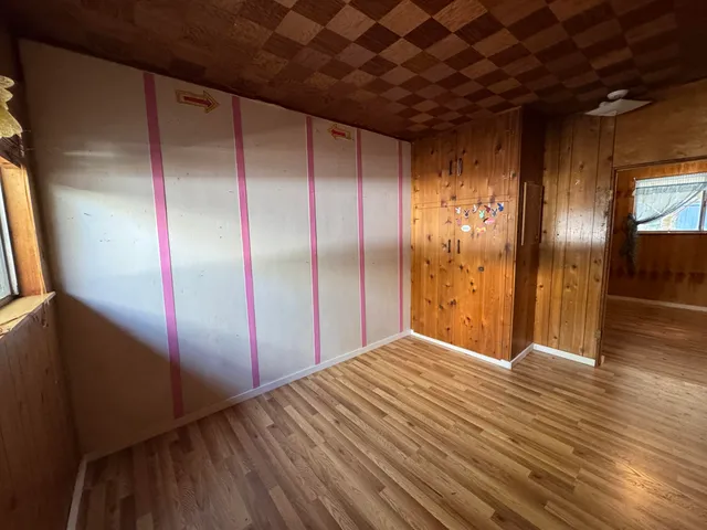 a view of hallway with wooden floor and chandelier