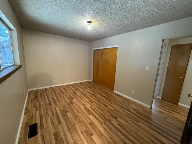 a backyard of a house with barbeque oven table and chairs