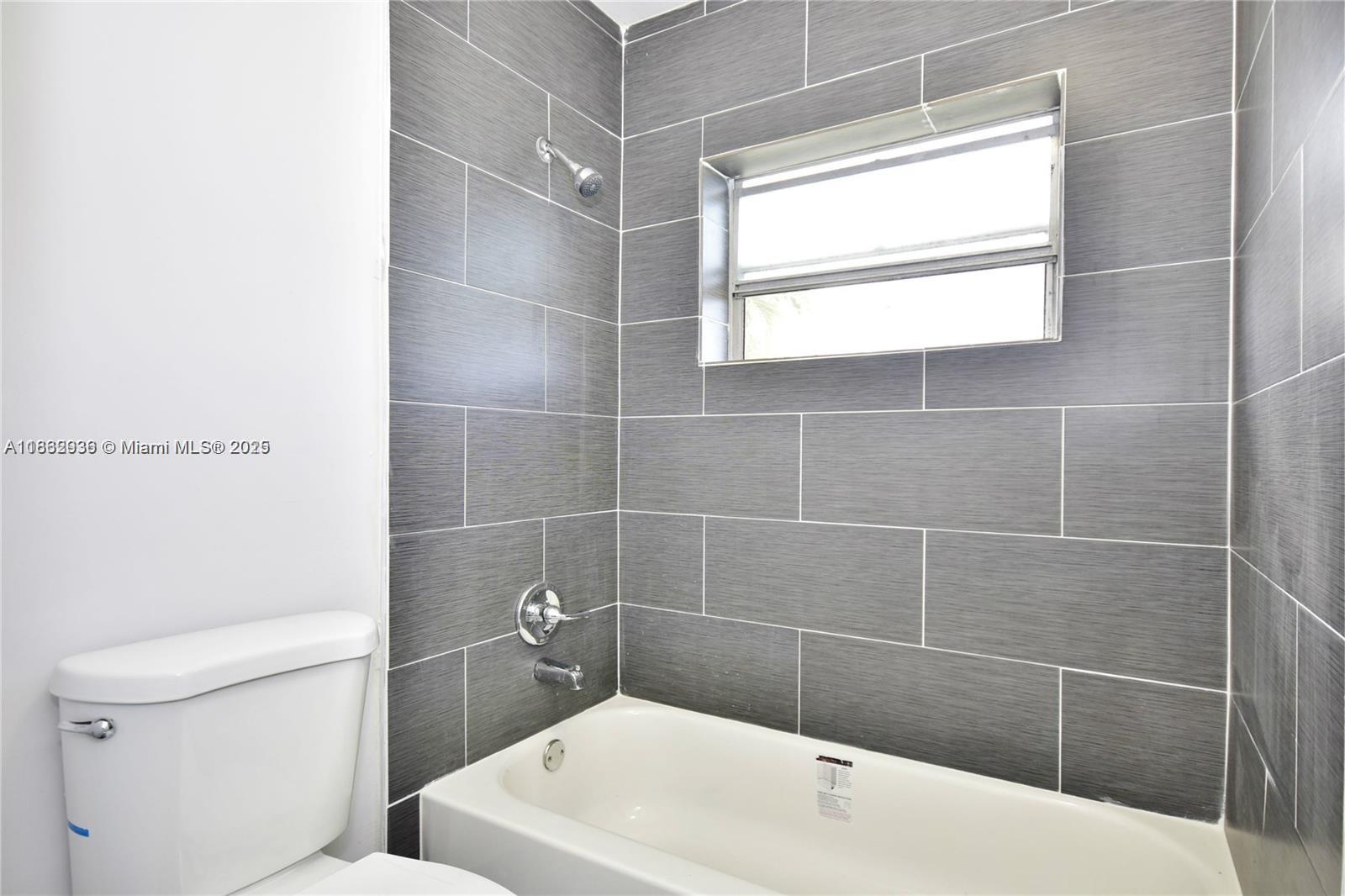 13201 Memorial Highway North Miami, FL 33161 - Photo 3 of 35 a bathroom with a white toilet and a shower