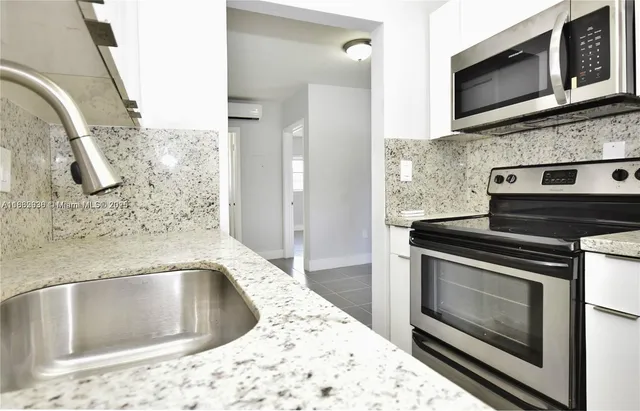 a kitchen with a stove microwave and sink