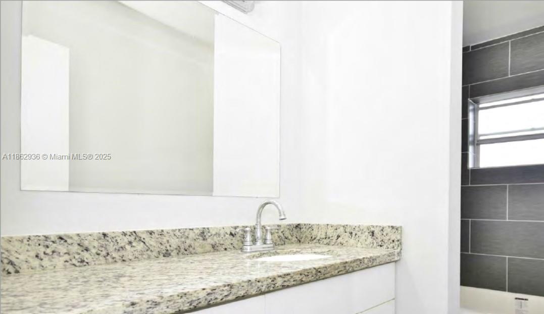 13201 Memorial Highway North Miami, FL 33161 - Photo 5 of 35 a bathroom with a granite countertop sink and a mirror
