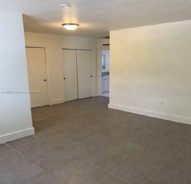 13201 Memorial Highway North Miami, FL 33161 - Photo 6 of 35 an empty room with closet and windows
