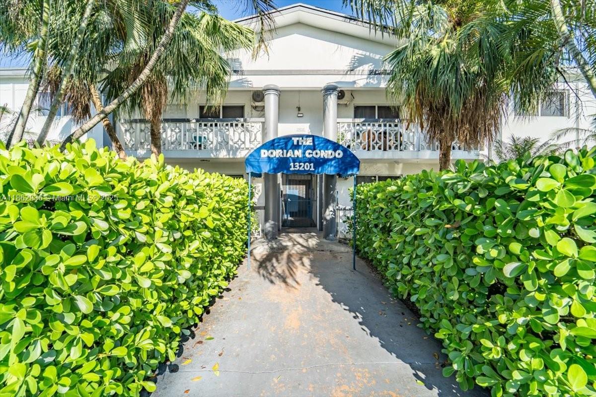 13201 Memorial Highway North Miami, FL 33161 - Photo 9 of 35 a front view of a house with a garden and potted plants