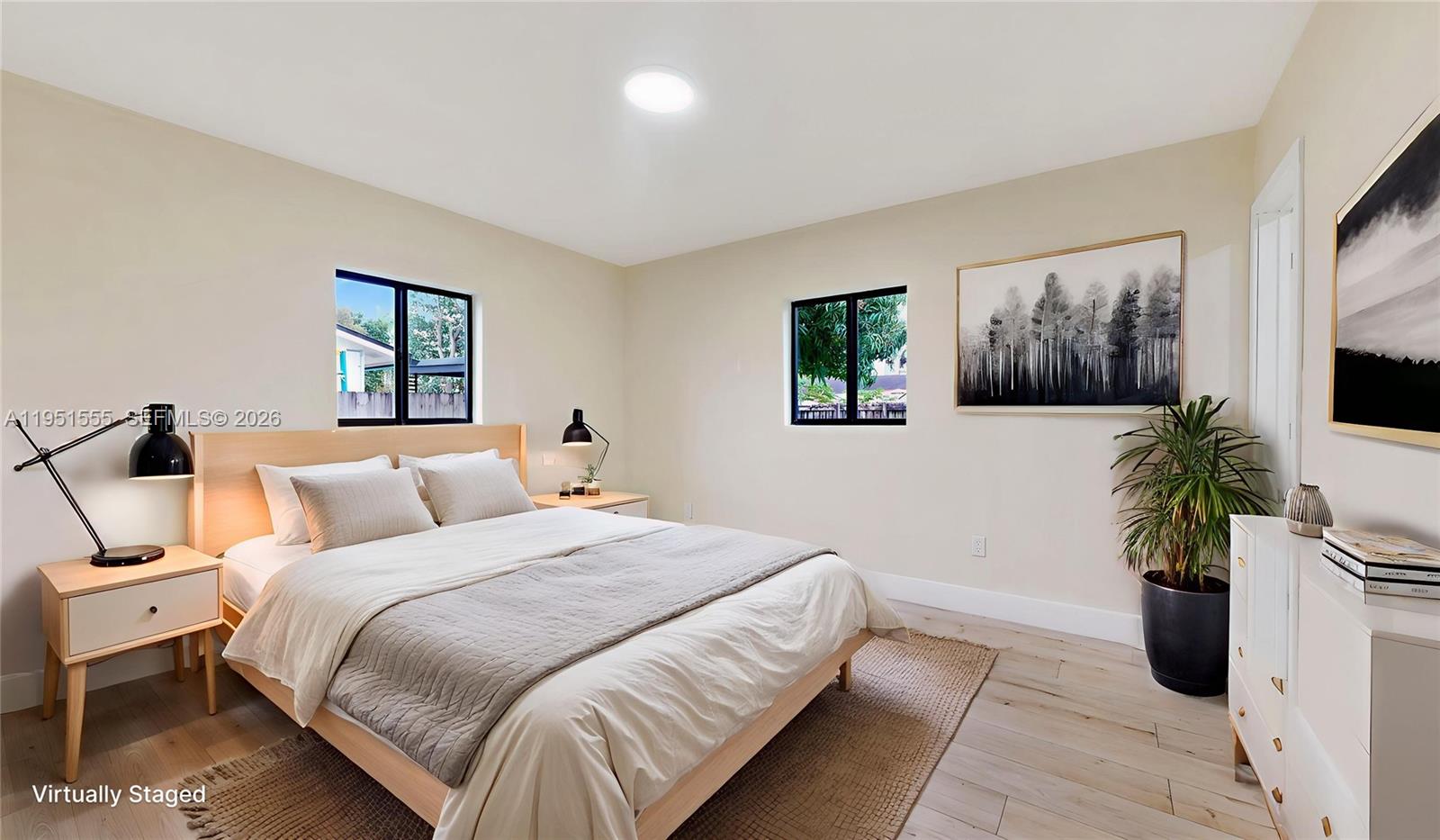 10944 Southwest 159th Terrace Miami, FL 33157 - Photo 11 of 25 a bedroom with a large bed and a potted plant