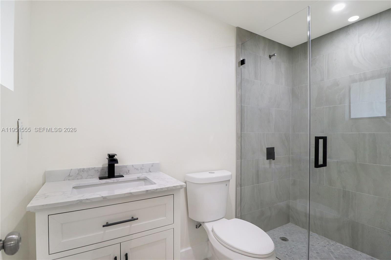 10944 Southwest 159th Terrace Miami, FL 33157 - Photo 13 of 25 a bathroom with a toilet sink and shower
