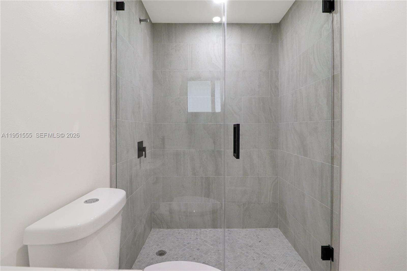 10944 Southwest 159th Terrace Miami, FL 33157 - Photo 14 of 25 a bathroom with a shower and toilet
