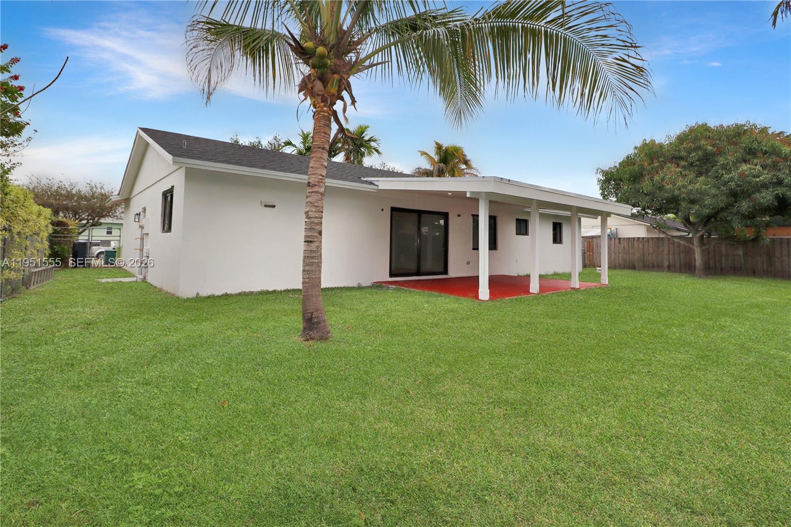 10944 Southwest 159th Terrace Miami, FL 33157 - Photo 23 of 25 a view of a house with a yard and palm tree