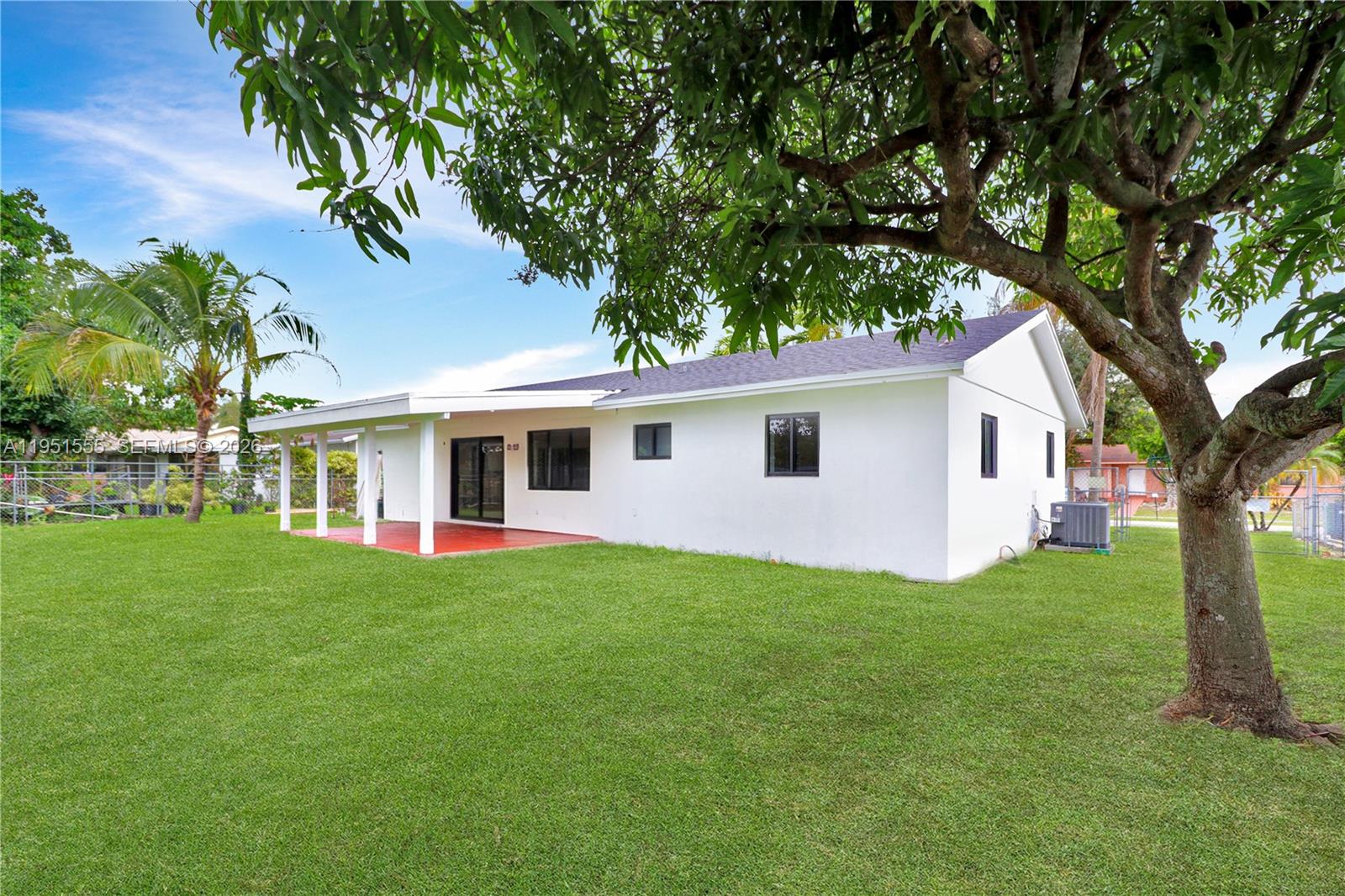 10944 Southwest 159th Terrace Miami, FL 33157 - Photo 24 of 25 a front view of a house with a garden