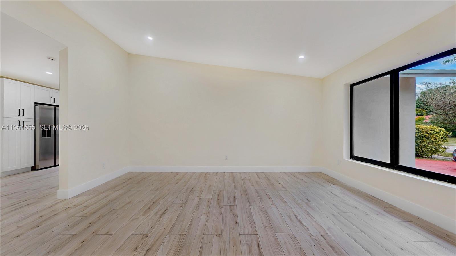 10944 Southwest 159th Terrace Miami, FL 33157 - Photo 5 of 25 a view of room with window and wooden floor