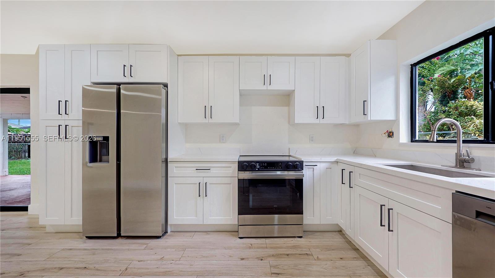 10944 Southwest 159th Terrace Miami, FL 33157 - Photo 7 of 25 a kitchen with a refrigerator sink and stove