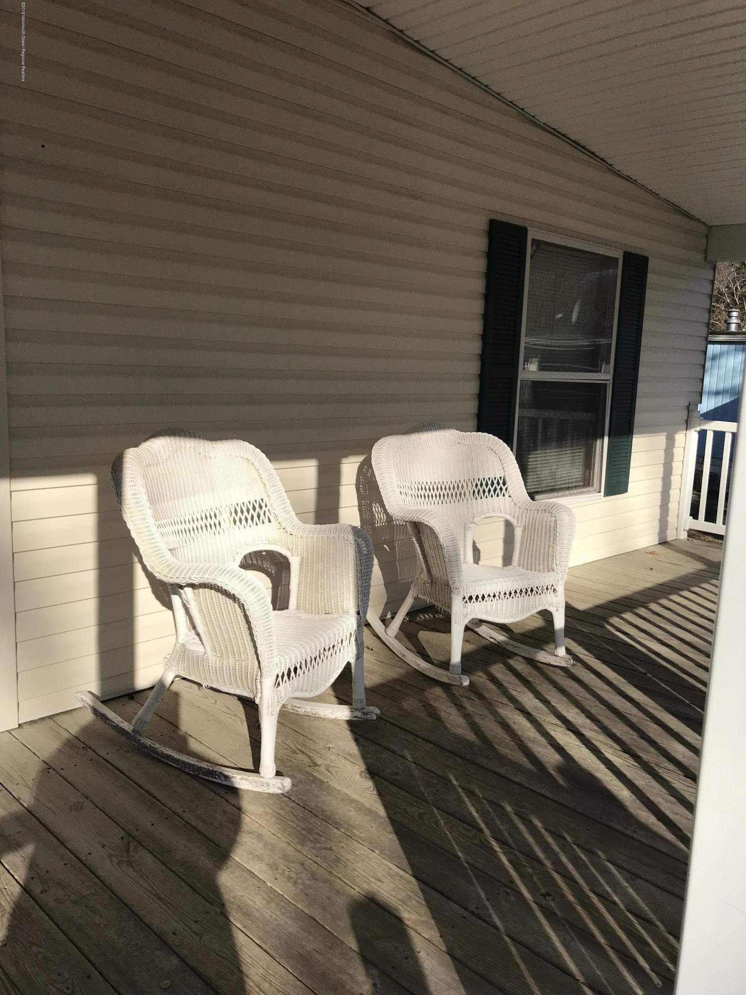 409 Roberts Road Toms River, NJ 08755 - Photo 3 of 34 a view of a patio with table and chairs with wooden floor and floor to ceiling window