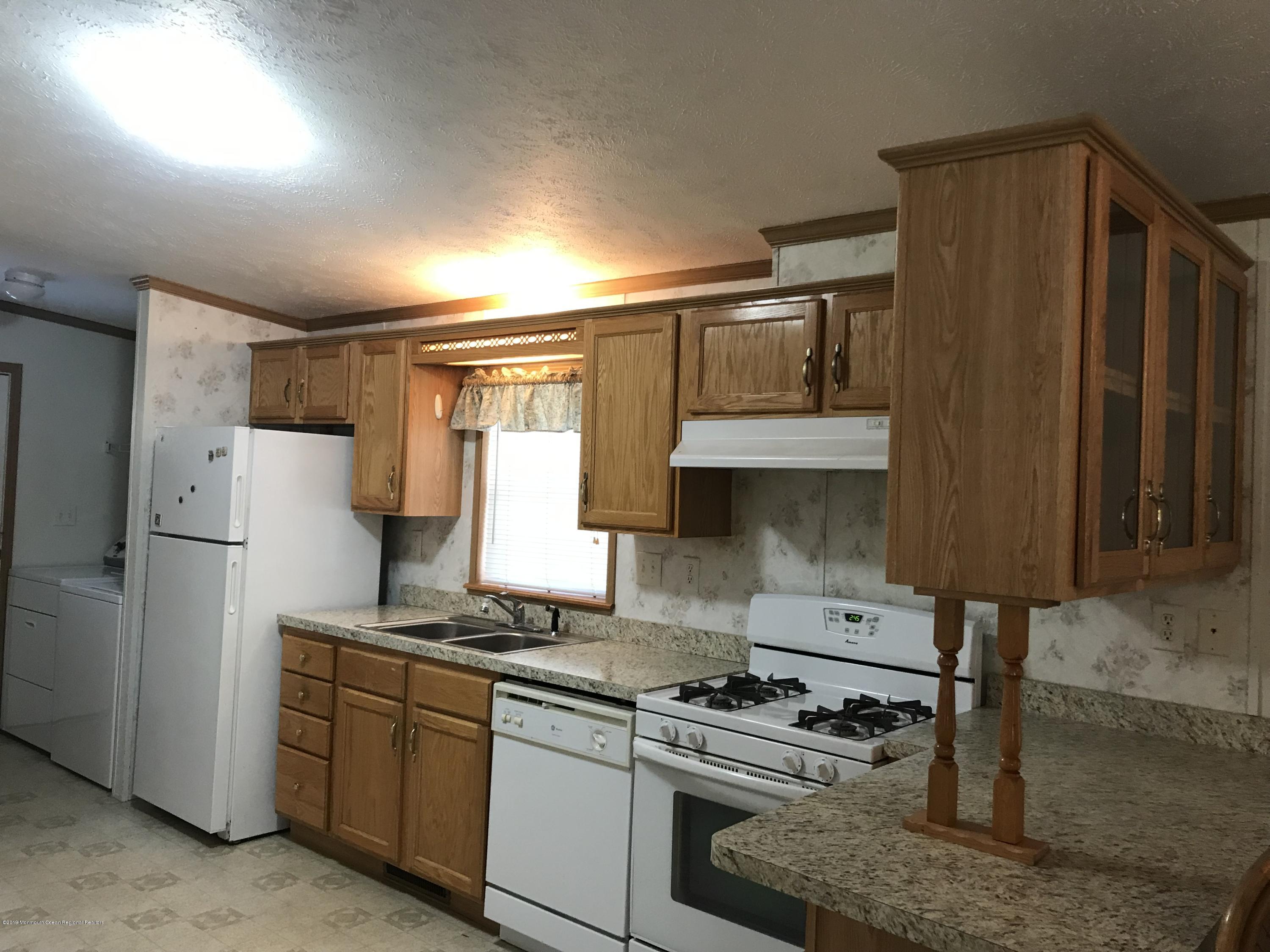 409 Roberts Road Toms River, NJ 08755 - Photo 8 of 34 a kitchen with a stove and a refrigerator