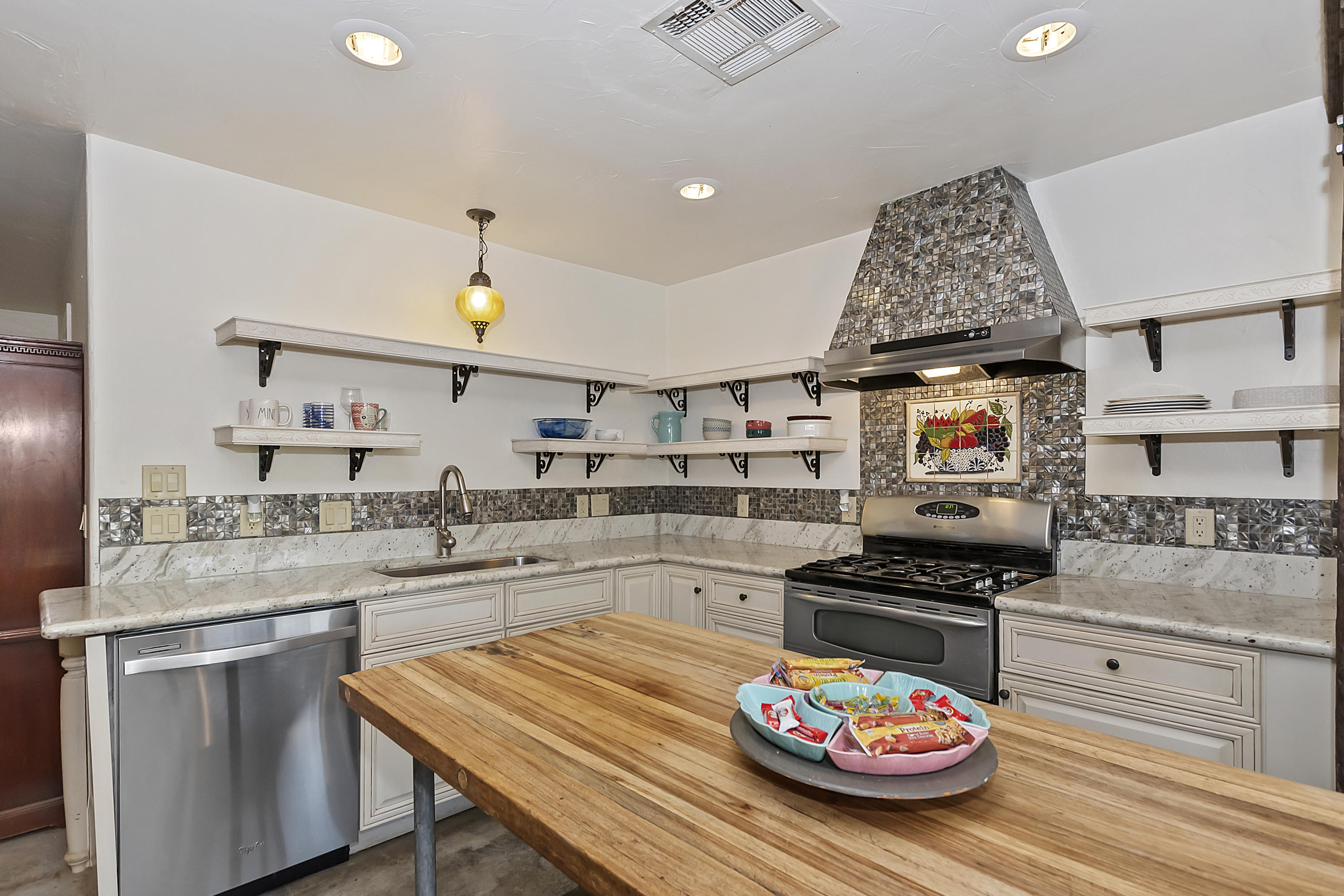 a kitchen with a stove a sink and a refrigerator