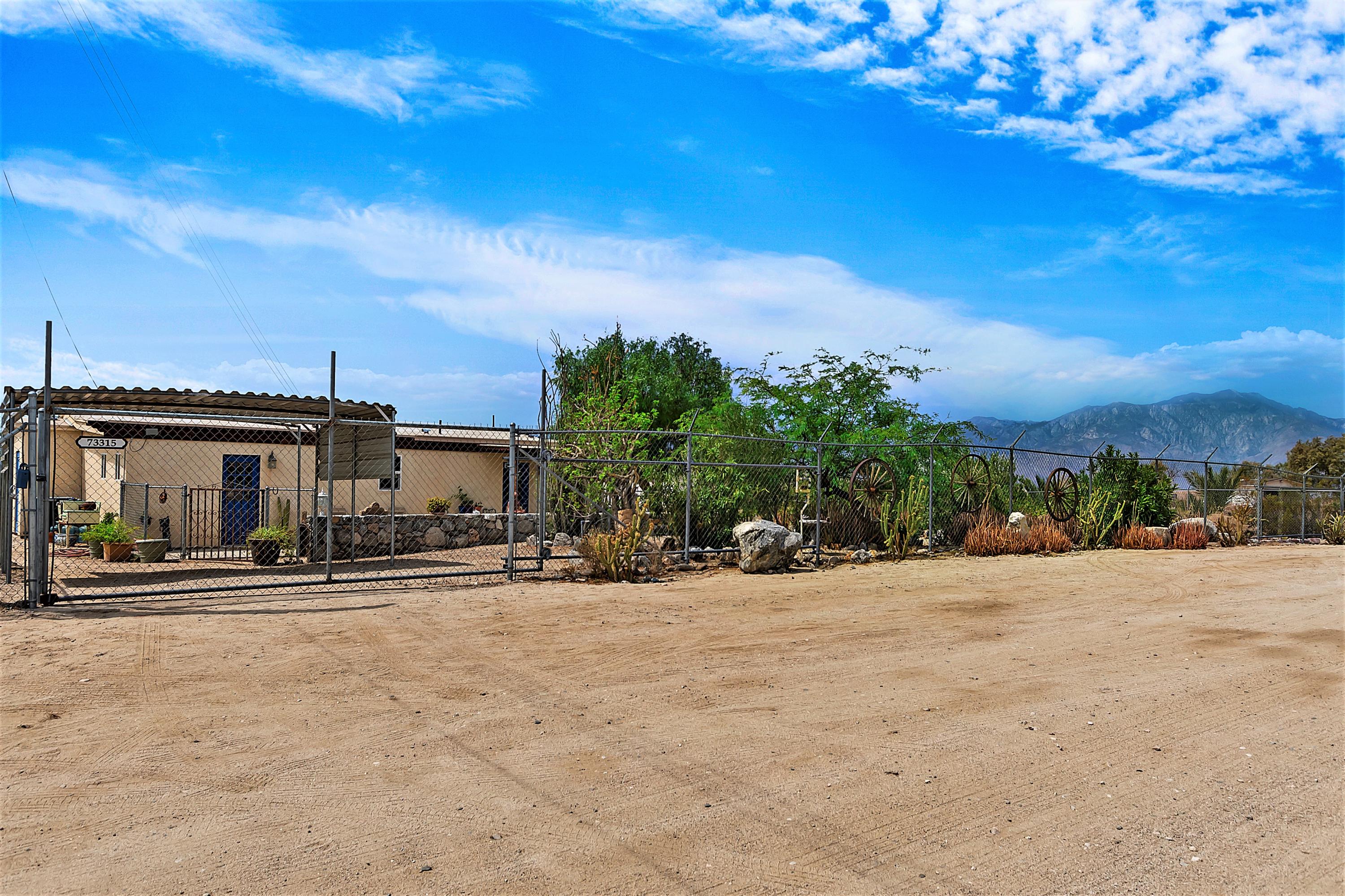 73315 Helms Road Desert Hot Springs, CA 92241 - Photo 2 of 41 a view of a house with a yard