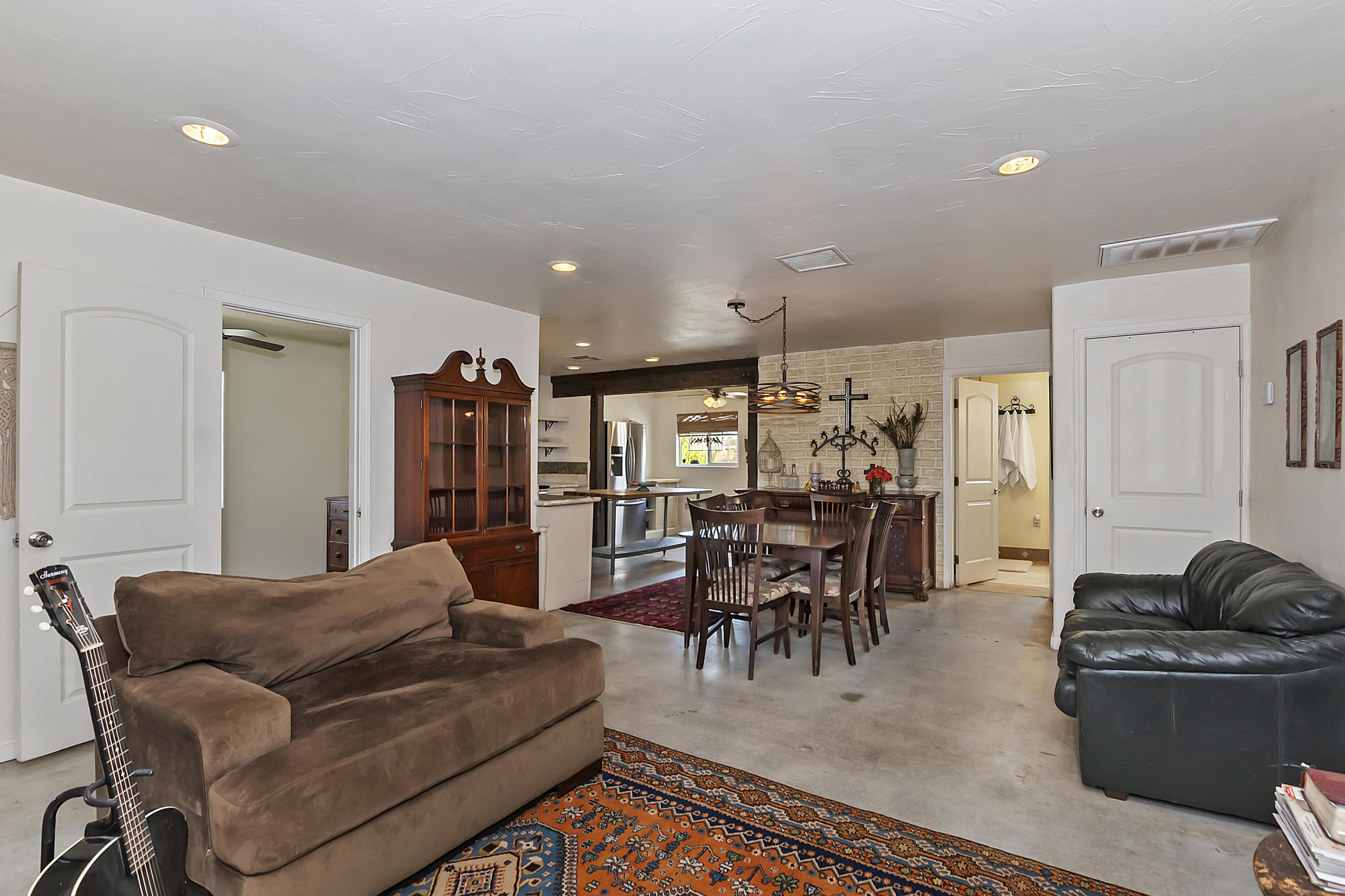 73315 Helms Road Desert Hot Springs, CA 92241 - Photo 11 of 41 a living room with furniture and a dining table with wooden floor