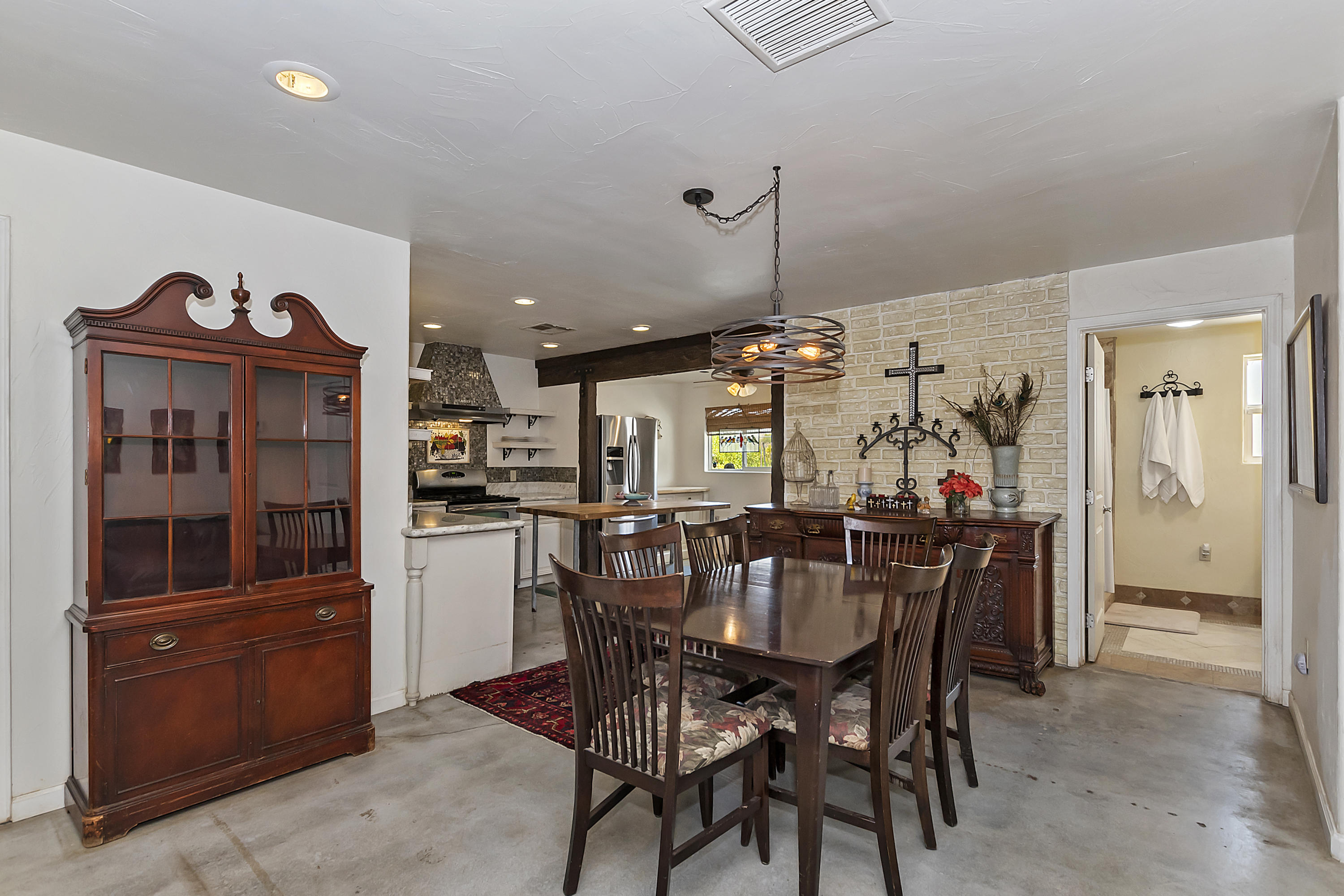 73315 Helms Road Desert Hot Springs, CA 92241 - Photo 13 of 41 a view of a dining room with furniture and chandelier