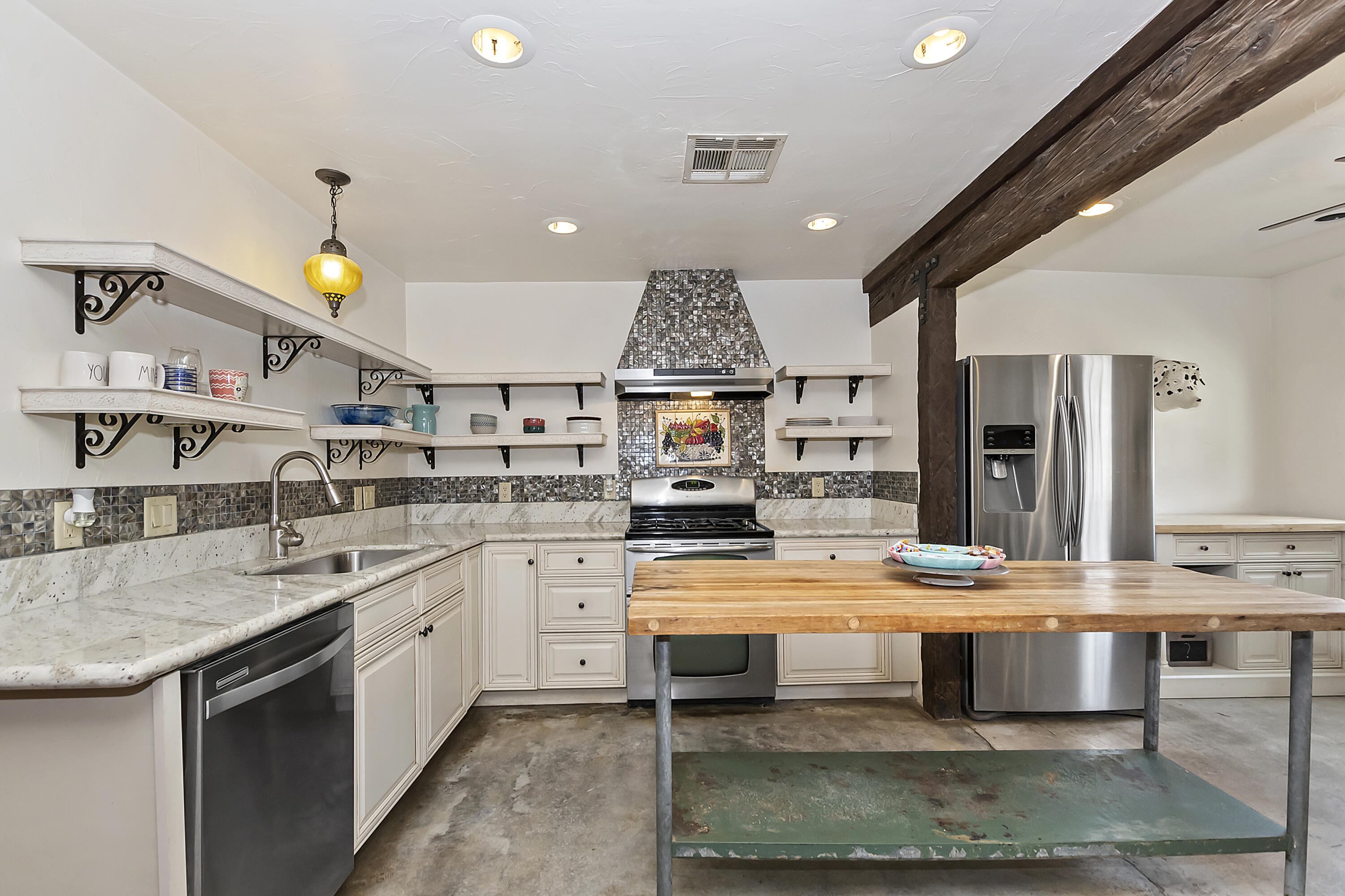 73315 Helms Road Desert Hot Springs, CA 92241 - Photo 15 of 41 a large kitchen with kitchen island a sink stainless steel appliances and cabinets