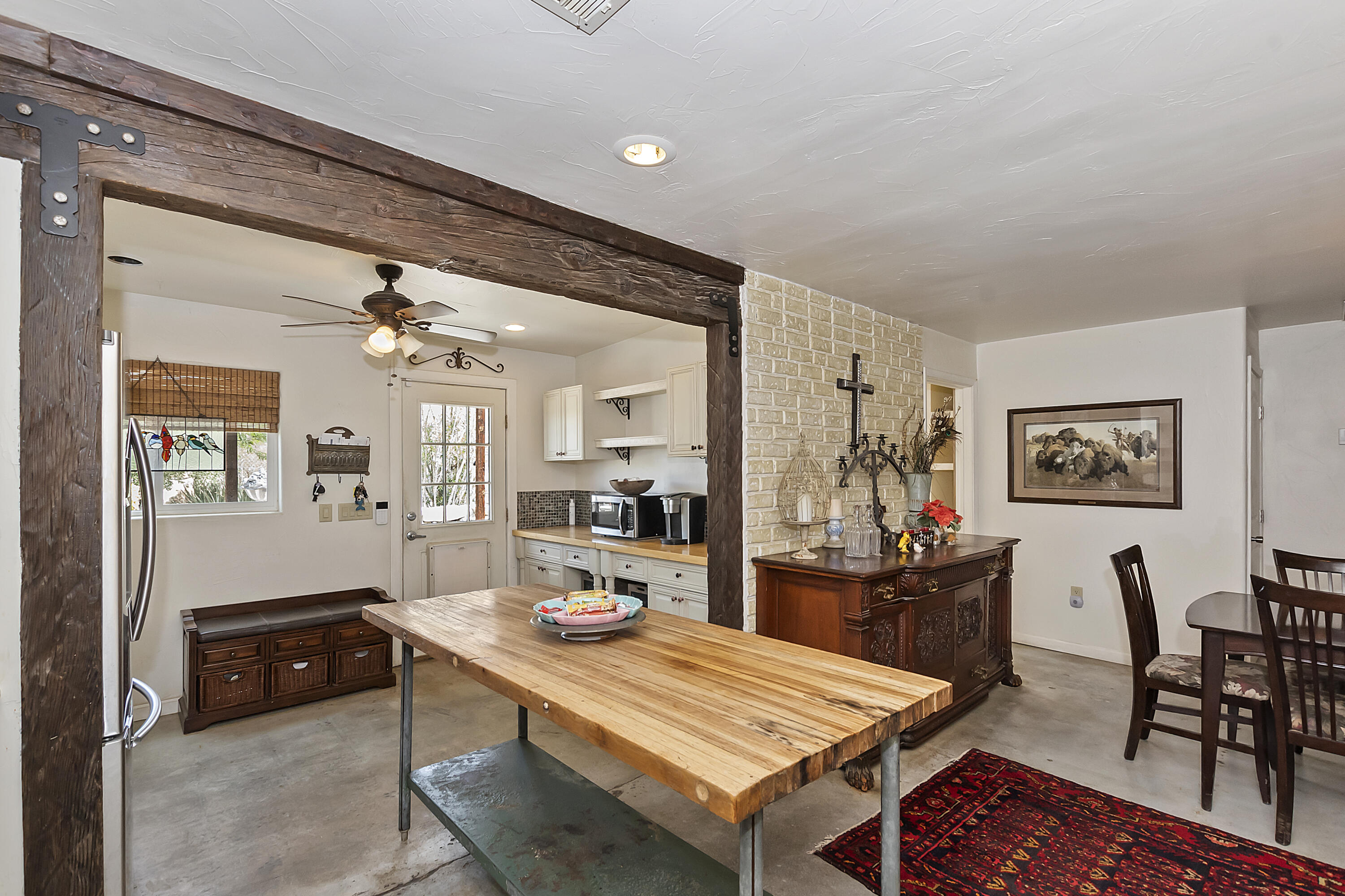 73315 Helms Road Desert Hot Springs, CA 92241 - Photo 17 of 41 a living room with dining table and chairs