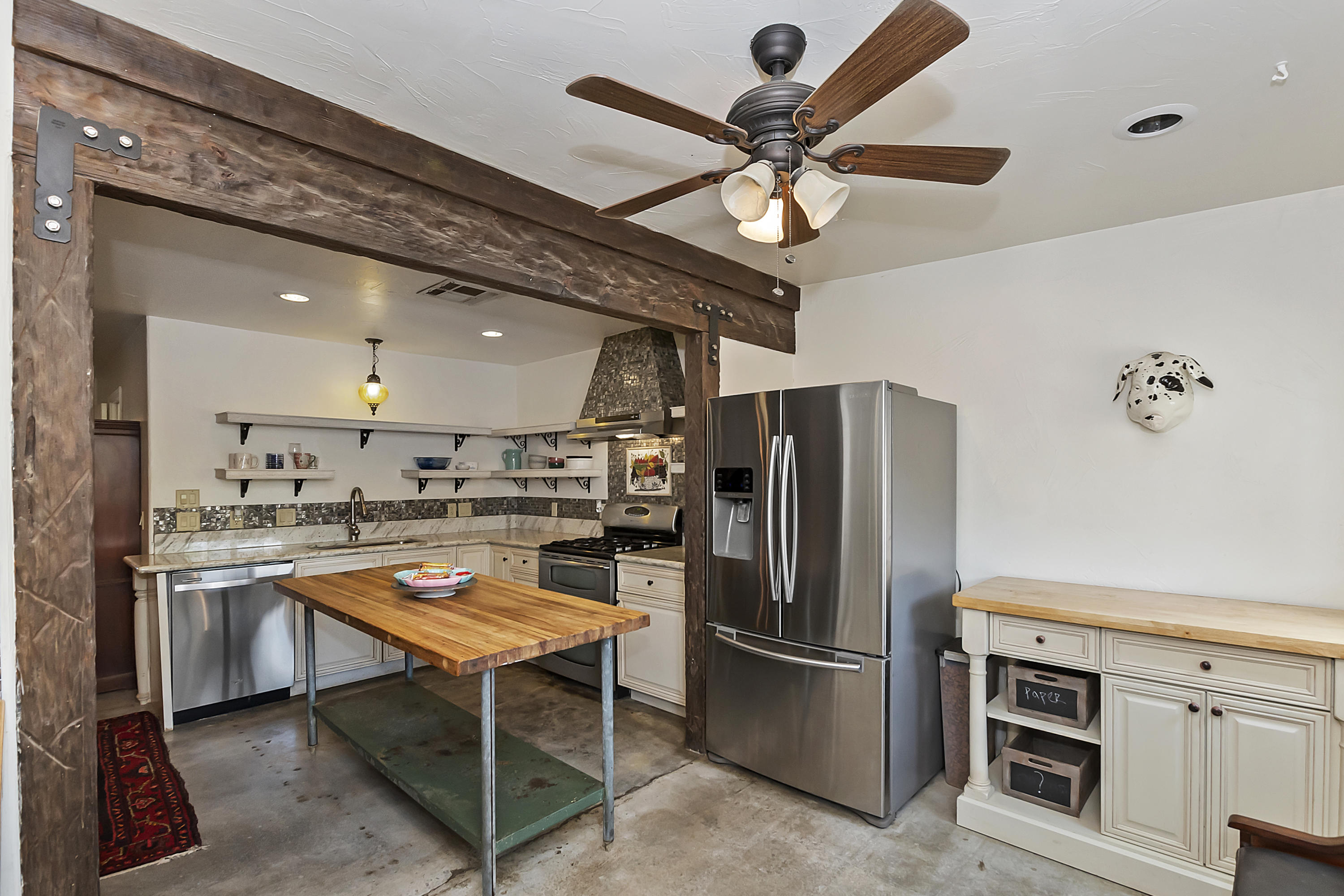 73315 Helms Road Desert Hot Springs, CA 92241 - Photo 19 of 41 a kitchen with a refrigerator a microwave and a stove