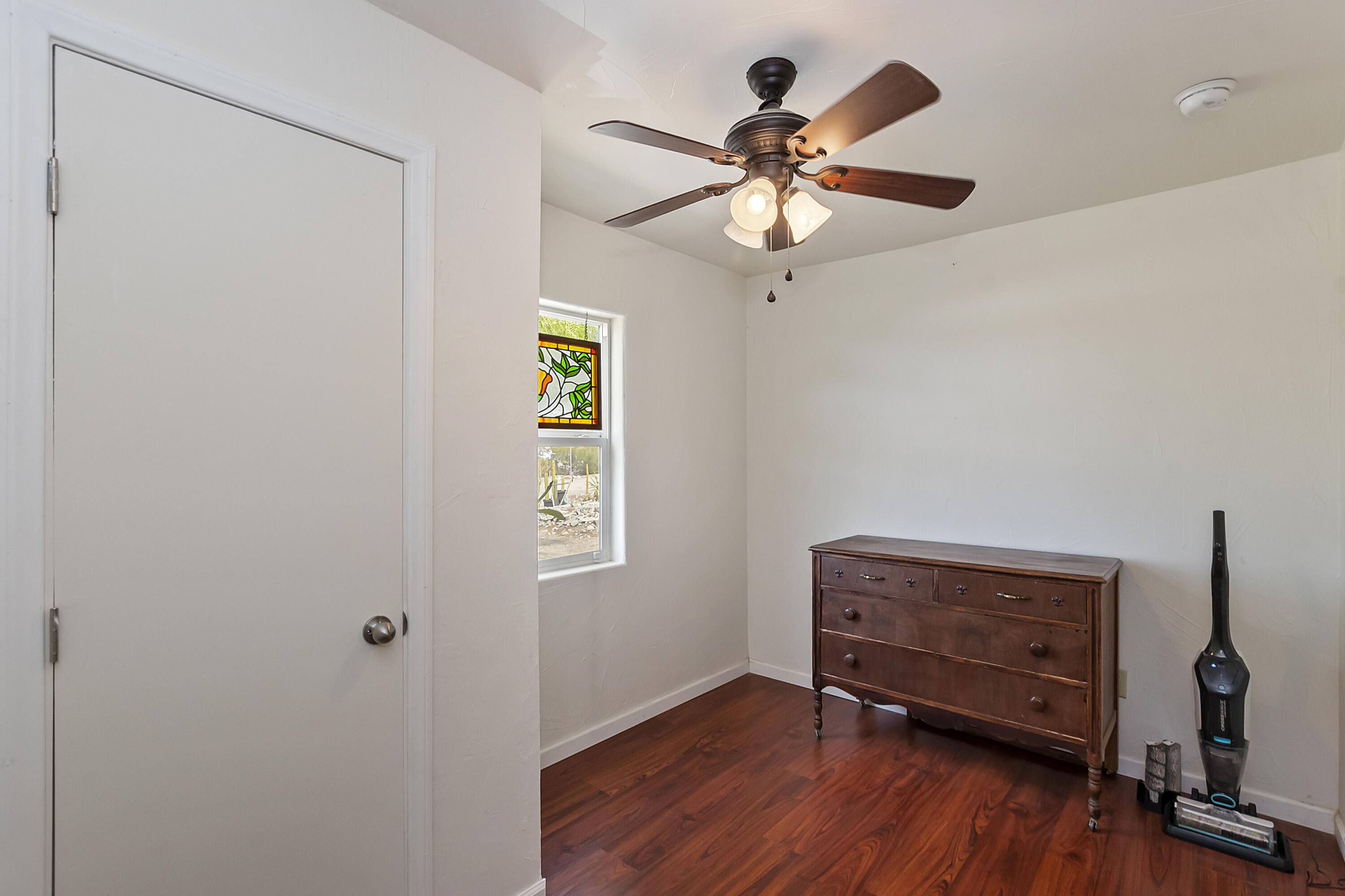 73315 Helms Road Desert Hot Springs, CA 92241 - Photo 20 of 41 a view of an empty room with a window and wooden floor