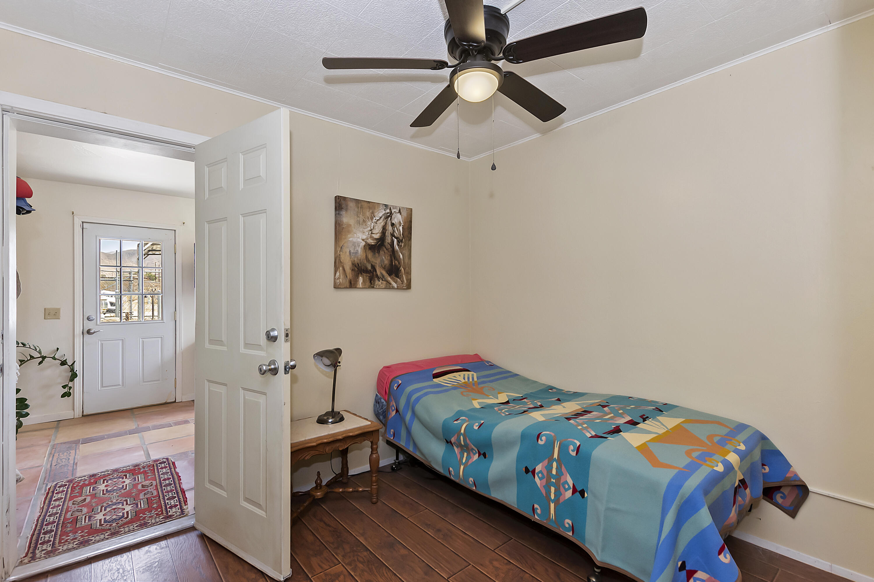 73315 Helms Road Desert Hot Springs, CA 92241 - Photo 21 of 41 a bedroom with a bed and wooden floor