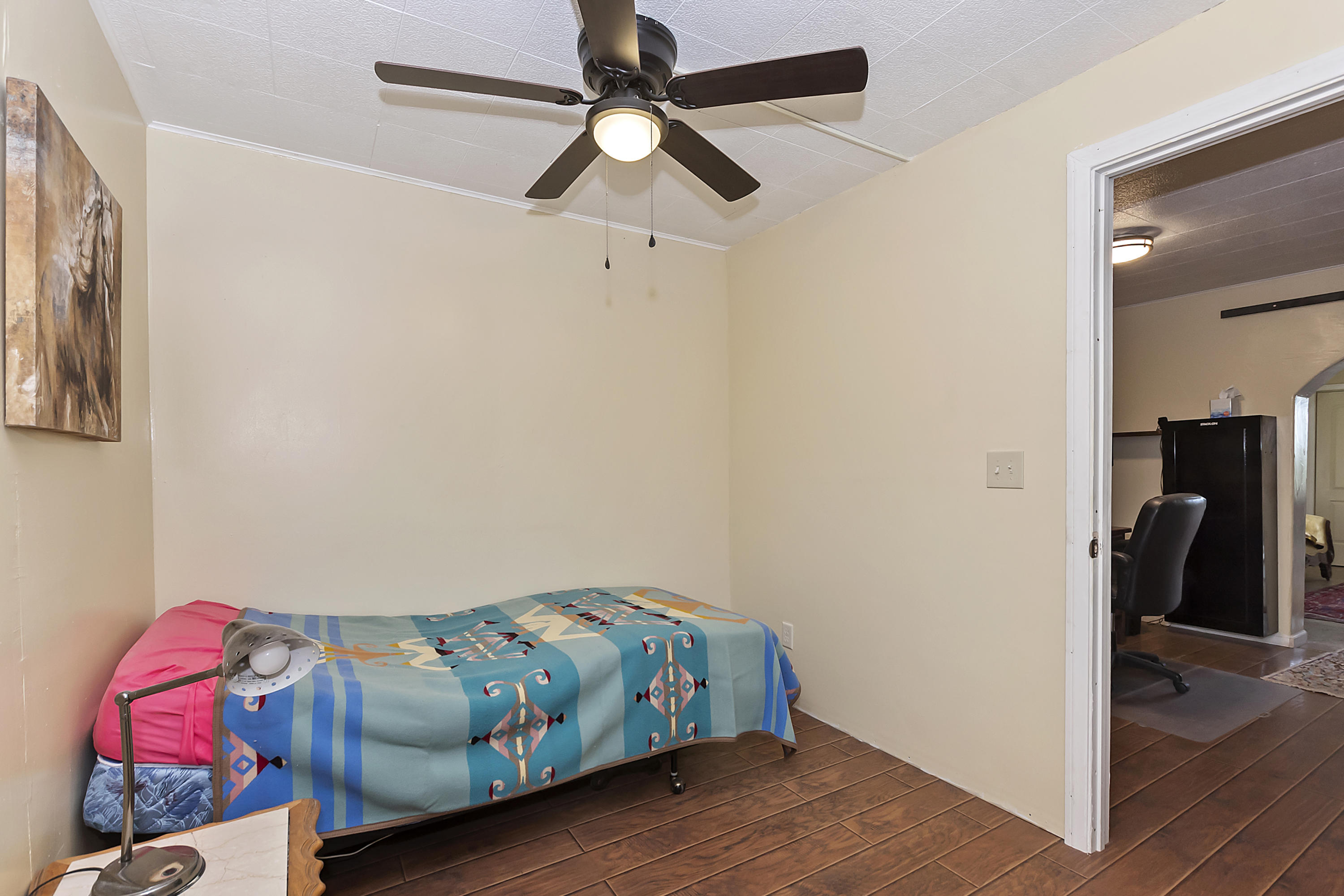 73315 Helms Road Desert Hot Springs, CA 92241 - Photo 22 of 41 a bedroom with a bed and wooden floor